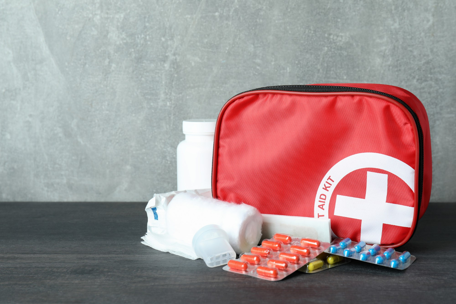 first-aid-medical-kit-dark-wooden-table