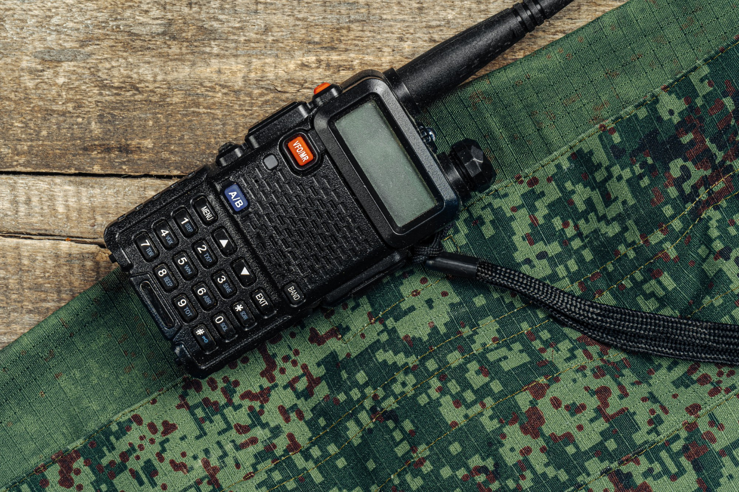 walkie-talkie-military-uniform-wooden-surface-top-view