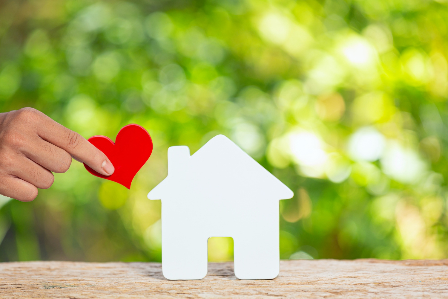 world-habitat-day-close-up-picture-model-house-hand-holding-paper-heart